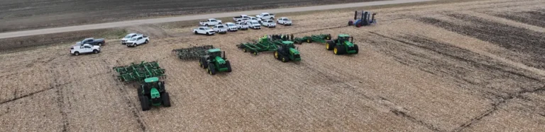 Tractors lined up in harvested field during farm event