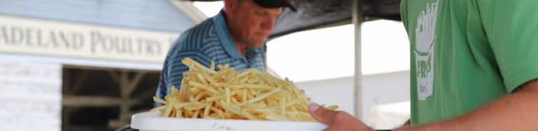 Volunteer serving fresh french fries
