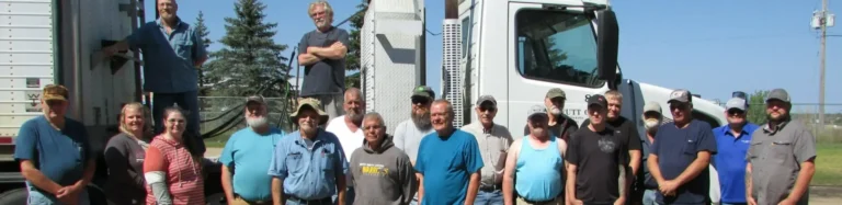 Group posing with semi