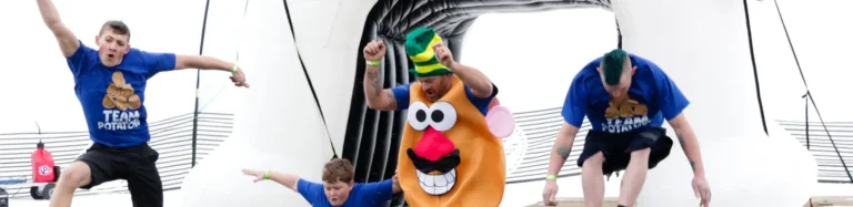 People jumping into icy water during polar plunge event wearing potato costumes
